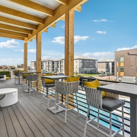 The essence of exceptional living a deck with tables and chairs on it