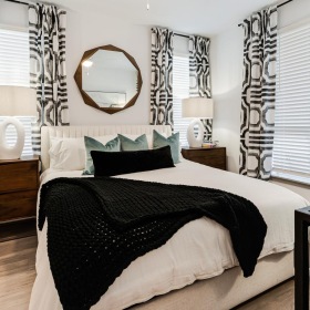 Generous bedroom offerings to fit every family a bedroom with a bed and a mirror
