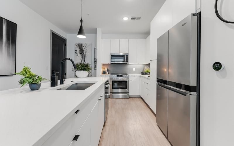 a kitchen with white cabinets